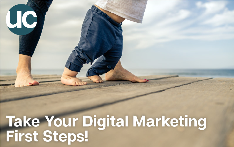 Take Your Digital Marketing First Steps! Featured Image: A woman helps a baby take his first steps on a boardwalk by the ocean