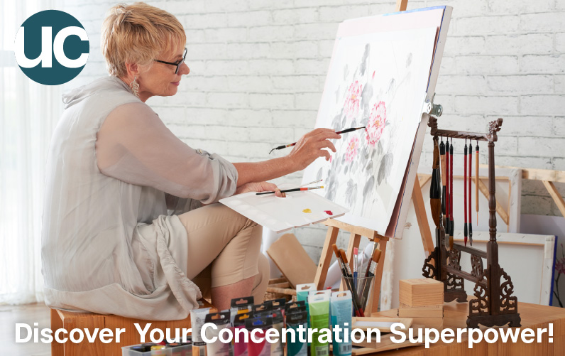 Discover Your Concentration Superpower - Featured Image: An older woman sits in her artist studio painting a canvas concentrating very hard